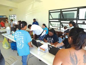 Community members register for the Commonwealth Healthcare Corp.’s mobile clinic outreach at the Tanapag Social Hall. (Jayson Camacho)