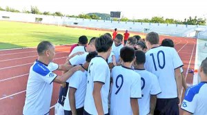 Players and officials of the CNMI U19 National Team huddle before a training match against Chonburi FC Academy U16 last Friday in Thailand. (Contributed Photo)