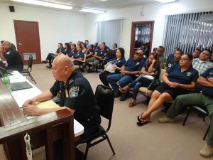 Law enforcement personnel listen in as lawmakers deliberate and eventually adopt their salary increases in a budget session yesterday. (Dennis B. Chan)