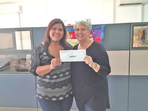 Mary Tenorio, representing the CNMI Community of Boise, Idaho, hands am $800 check to Karidat executive director Lauri Ogurmoro. (Contributed Photo)