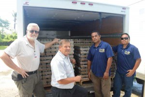 D&Q resident manager Max Kretzers, second from left, is joined by two D&Q staff in turning over four pallets of Black Label Luncheon Loaf donated by Hormel Food to Salvation Army pastor Wayne Gillespie, left. (Frauleine S. Villanueva)