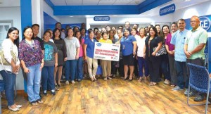 Rose A. Soledad, IT&E general manager; Velma Ann Palacios, IT&E head of Network; Janice A. Tenorio, IT&E Customer Service manager; John M. Compton, IT&E chief operating officer; and Steven Carrara, IT&E corporate legal counsel, pose with representatives of Parent Teacher Organization Association and other non-profit organizations. (Contributed Photo)