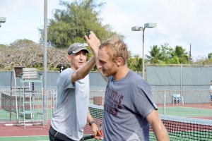 Jeff Race, left, and Luke Beling exchange high fives after scoring a point against Tommy Choi and Amami Sakano in last year’s PIC Tennis Championships at the Pacific Islands Club hard court. (Roselyn B. Monroyo) 