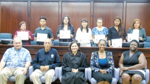 The seven newest U.S. citizens have their picture taken yesterday with, from left, front row, Delegate Gregorio Kilili C. Sablan, Federal Emergency Management Agency federal coordinating officer Stephen DeBlasio Sr., U.S. District Court for the NMI Chief Judge Ramona V. Manglona, Immigration Services supervisory officer Lakeisha C. Lee, and Immigration Services officer Shelia Kelty.  (Ferdie De La Torre)