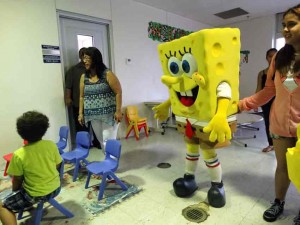 Nickelodeon’s Spongebob Squarepants visits the children’s clinic at the Commonwealth Health Center yesterday morning under the auspices of Docomo Pacific, which is hosting a Kids4Kids Carnival on the island. At left is DPH director Margaret Aldan calling the children. (Jayson Camacho)