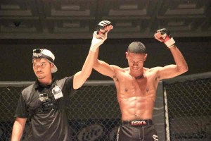 Jordan “The Machine” Manglona, right, reacts after winning the flyweight title against Ernie Santos of Team High Blood Pressure in Rites of Passage 18: Warpath last July. (Jon Perez)