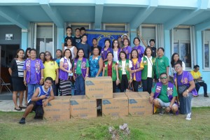 Members of the Lions Club International turn over boxes of tissue rolls to Marianas High School principal Cherlyn Cabrera, front row center, and MHS students on Friday. (Frauleine S. Villanueva)
