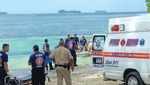 Department of Fire and Emergency Medical Services personnel, with the assistance of a bystander, use the latter’s boat in pulling out Isidro Wabol, who was found dead and floating outside the reef of Sugar Dock in Chalan Kanoa yesterday afternoon. Photo shows DFEMS personnel transferring the body to a waiting ambulance. (Derek Gersonde)