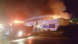 Firefighters spray water into the building of Kevin’s Mart on Tun Segundo Street in Chalan Kanoa. Arson investigators determined that an overloaded multi-plug outlet caused the blaze. The Department of Fire and Emergency Medical Services considers this case closed. (Derek Gersonde)