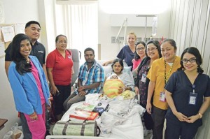 Staff of the Commonwealth Health Center and representatives of Marianas Pacific Distributors Inc. pose for a picture with the first newborn baby of 2017. From left to right: Arienne Pandi RN, Marpac representatives Frank Mettao and Shirley Santos, family of the 2017 baby, April Liske-Clark RN, Edna Abantao RN, nursing supervisor Joy Oblea RN, Mary Ann Acido RN, and Jennifer Demapan RN. (Erwin Encinares)