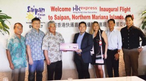 From left Marianas Visitors Authority board members Nick Nishikawa and Jerry Tan, acting governor Arnold Palacios, HK Express general manager Sherman Luk, Hotel Association of the Northern Mariana Islands chair Gloria Cavanagh, Tom Liu, and MVA managing director Chris Concepcion pose for a photo yesterday, after the HK Express inaugural flight. (Erwin Encinares)