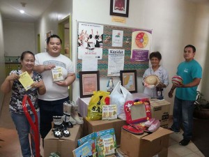 Karidat Social Services staff shows the clothes, toys, and other items donated by companies and individuals to the Joeten-Kiyu Public Library last December. (Contributed Photo)