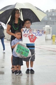 Friends and family cheer as Los Angeles-class attack submarine USS Topeka pulls in to Apra Harbor Jan 28. Topeka is returning to homeport following a two-month forward operating period to the Western Pacific. (JAMICA JOHNSON)