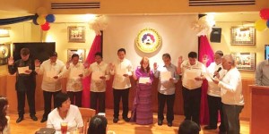Philippine honorary consul Glicerio “Eli” Arago, right, swears in the new officers of the United Filipino Organization led by president Marlon Regaton, second right, during an induction ceremony held last Dec. 9. (Contributed Photo)