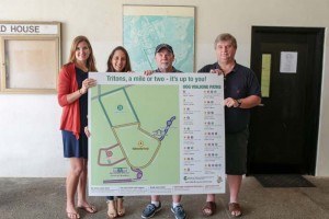 University of Guam officials hold up a new walking/running trail for the UOG campus. The UOG College of Natural and Applied Sciences Research Extension and Triton Athletics collaborated on walking/running trail maps for several villages. The maps are available online at http://cnas-re.uog.edu/walking-maps/.From left: CNAS-RE graphic artist Emily Shipp, assistant professor of Nutrition Dr. Tanisha Aflague, CNAS associate dean for Research and Extension Jim Hollyer, and UOG Athletic director Doug Palmer. (Contributed Photo)