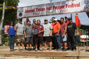 Marianas Visitors Authority board member Juan Barcinas and MVA staff receive a plaque of appreciation from Tinian Mayor Joey Patrick San Nicolas, in white, at the 13th Annual Tinian Hot Pepper Festival on Feb. 18, 2017, in the Marianas. Also pictured are Gov. Ralph DLG Torres, fourth from left, and other dignitaries. (MVA)