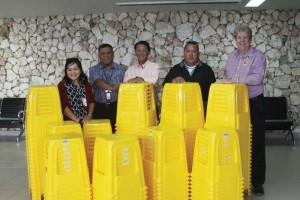 Saipan Travel Inc. president Tom Liu, center, donates 150 chairs to the Commonwealth Ports Authority at the  Francisco C. Ada- Saipan International Airport arrivals corridor on Feb. 14, 2017.  From left are Marianas Visitors Authority acting managing director Judy Torres, CPA deputy executive director Edward Mendiola, Liu, CPA executive director Chris Tenorio, and MVA marketing manager Bruce Bateman. (MVA)