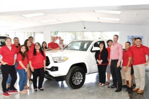 Atkins Kroll Toyota operations manager Alex Hammett, fourth from right, poses with NMC president Dr. Carmen Fernandez, sixth from right, and NMC students next to the 2017 Toyota Tacoma that will be featured as a hole-in-one prize at the NMC Foundation Golf Tournament on March 18. Also in photo are NMC Foundation board chair Mary Tenorio, seventh from left, and Atkins Kroll manager Doug Brennan, eigth from left. (Contributed Photo)