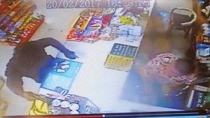 This frame grab from a surveillance camera shows an armed robbery at LZ Market in Dandan on Monday night. The suspect pointed a handgun at the store owner, demanded money, and sprayed pepper mace on the victim. The suspect managed to run off with $800 cash. The robbery lasted less than a minute. (Ferdie de la Torre)
