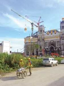 A tower crane lifts a bronze structure for installation atop the building of the Imperial Pacific Casino and Resort project in Garapan in this photo taken a week ago. If completed, the four-story casino building features a Beaux-Arts architectural style of the famed Casino de Monte Carlo. It was reported that the soft opening of the new casino will be on March 31, 2017. (Ferdie de la Torre)