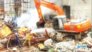Department of Fire and Emergency Medical Services personnel put out the trash fire that hit the construction site of Imperial Pacific Resort in Garapan yesterday. (Contributed Photo)