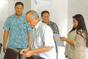 Department of Public Lands Secretary Marianne Teregeyo, right, briefs Gov. Ralph DLG Torres on yesterday's lottery drawing of revoked lands at the DPL office in Dandan as Dino Manning, who participated, looks on. (Jon Perez)