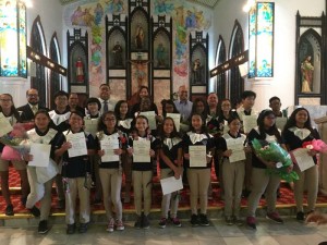 Newly inducted members of Mount Carmel School’s Immaculate Conception chapter of the National Junior Honor Society gather for a photo with Bishop Ryan Jimenez and school officials. (Contributed Photo)