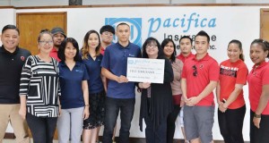 Pacifica Insurance representatives presents a $5,000 hole-in-one check to NMC president Dr. Carmen Fernandez, sixth from right, together with NMC students, which will be up for grabs at the NMC golf tournament on Saturday, March 18, 2017. (Contributed Photo)