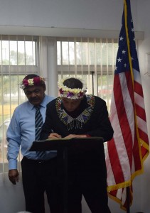 Vicente Cruz Santos Jr., right, signs the document formalizing his post as the new Northern Islands mayor while acting governor Victor B. Hocog looks on. (Contributed Photo)