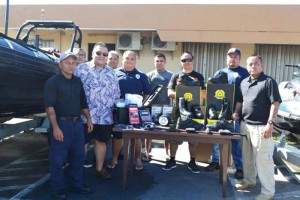 Tinian Mayor Joey P. San Nicolas and Department of Public Safety resident director Juan Santos receive the new equipment. (Contributed Photo)