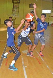 An Ol’Aces Elite player, center, fumbles as he faces two Mt. Carmel School defenders during the first half of their boys U18 division game in the Diaz youth caging last Tuesday at the Gilbert C. Ada Gymnasium. (Roselyn B. Monroyo)