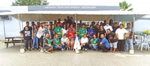 Members and volunteers of the CNMI Homeless Coalition have their photo taken in front of the Northern Marianas Housing Corp. (Kimberly A. Bautista)