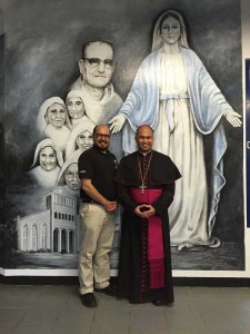 Bishop Ryan P. Jimenez (right), who is the corporate sole of Mount Carmel School, Inc., meets with school president Galvin Deleon Guerrero in front of the school’s mural honoring the founders of the school, Father Arnold Bendowski and the sisters of the Mercedarian Missionaries of Berriz. (Contributed Photo)