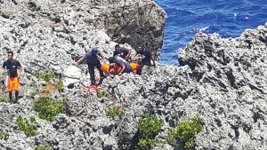Department of Fire and Emergency Medical Services search and rescue personnel rappelled from a cliff to pull out a Korean woman who nearly drowned while diving with her husband and an instructor at the Grotto area in Marpi last Saturday. (Derek Gersonde)