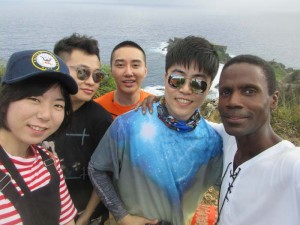 Alex Lee (back row, orange shirt) and the China Travel Channel film production crew with author/guide Walt Goodridge overlooking Forbidden Island in Kagman, Saipan, Northern Mariana Islands. (Contributed Photo) 