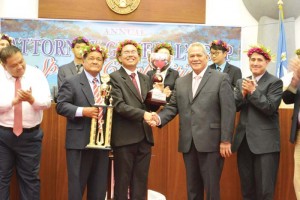Zeno Deleon Guerrero Jr., center, shakes the hand of Attorney General Edward Manibusan as Chief Justice Alexandro, left, holds the trophy while posing for a picture after the announcement of the Attorney General’s Cup speech competition winners last Friday.(Erwin Encinares)