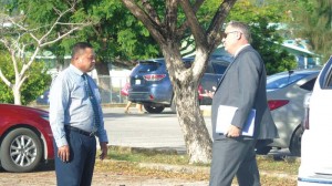 Defense counsel Mark B. Hanson gestures as he talks with his client, former Department of Public Safety deputy commissioner Ambrosio T. Ogumoro, in the parking lot of the Judiciary Complex in Susupe yesterday afternoon. Ogumoro was found guilty of two corruption charges and acquitted of four other charges. (Ferdie de la Torre)