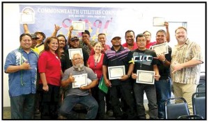 Gov. Ralph DLG Torres, left, recognizes employees of the Commonwealth Utilities Corp. during a rescheduled ceremony last Thursday. (Contributed Photo)