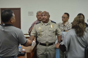 Public Safety Commissioner Robert Guerrero shakes Rep. Frank Aguon’s (R-Saipan) hand with Rep. John Paul Sablan (R-Saipan), Gregorio Sablan Jr. (R-Saipan), and Alice Igitol (R-Saipan) in the background during yesterday’s budget hearing. (Erwin Encinares)