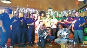Police officers and firefighters have a group photo with Hard Rock Café Saipan staff during the burger eating contest for the Guns & Hoses event sponsored by Hard Rock Café on Wednesday. Police officers defeated firefighters, who are the perennial winners. (Ferdie de la Torre)