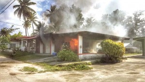 Firefighters try to extinguish a fire in the garage of a house in Chalan Kanoa’s Laly Four yesterday afternoon. Arson in investigators are still conducting investigation about the cause of the fire. (Derek Gersonde)