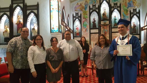Mt. Carmel School’s Class of 1990 awards a $1,000 scholarship to Nathaniel Snodgrass at the graduation ceremony on May 28, 2017., at the Mount Carmel Cathedral. (Contributed Photo)