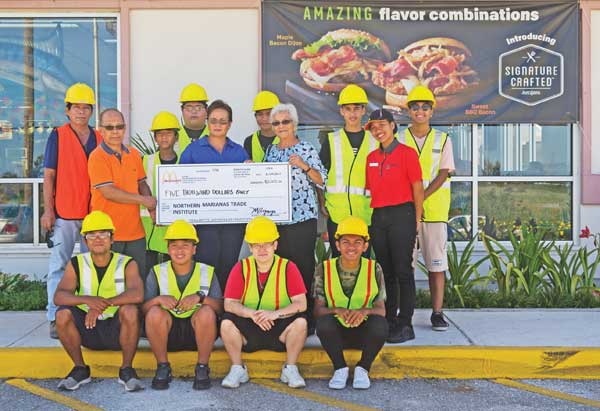 Marcia Ayuyu, owner of JCA Inc., which operates McDonald’s of Guam and Saipan, turns over a $5,000 donation to Agnes M. McPhetres, CEO of the Northern Marianas Trades Institute. (Contributed Photo)