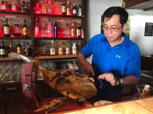 Aqua Resort Club F&B operations manager Rom Manzon carves the featured appetizer that the Vino Bar offers during the Tiempo Del Vino. (Kimberly A. Bautista)