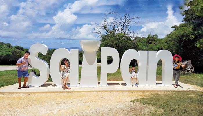 Saipan resident Zhang Wei gives his aunt Li Pao Ran, cousin Lu Wei, and niece Qi Yuxin a tour around the island yesterday and they stopped by the Saipan giant sign to have their photo taken. “It is my relatives’ first time on Saipan. They are enjoying and like what they see. They want their photo with the giant Saipan signage so family and friends back in China know they are here,” Wei said. The giant Saipan signage located along Marpi Road going to Grotto was unveiled last July 10, 2017 by the Marianas Visitor’s Authority in their continued efforts to promote tourism in the CNMI and have people hare their destination information with their family and friends. (Bea Cabrera)