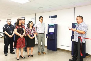 Commonwealth Ports Authority executive director Chris Tenorio, right, delivers his remarks during yesterday afternoon's unveiling of the seven automated passport control machines at the Francisco C. Ada-Saipan International Airport. The event was also participated by Marianas Visitors Authority managing director Christopher Concepcion, acting CPA board chair Thomas Villagomez, and Imperial Pacific International majority shareholder Margaret Cui Lijie. The APC machines are designed to reduce the processing time for arriving passengers. (Saipan Tribune) 