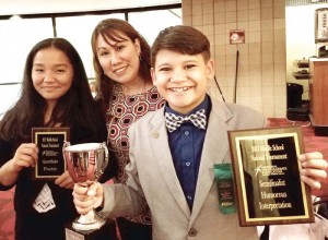 Tioni Reyes, left, and Jonathan Wolf, right, pose with their awards and their coach, Johanne Kristine Wolf, center. (Contributed Photo)