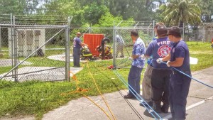 Department of Fire and Emergency Medical Services firefighters and Commonwealth Utilities Corp. crew assist DFEMS-Search and Rescue Unit and Hazmat Unit in retrieving the bodies of three Filipino workers from the 24-foot sewer well at CUC’s lift station at Pakpak Beach in San Antonio on Friday before noon. Investigators believe the workers died due toxic gas exposure and drowning. (Derek Gersonde)
