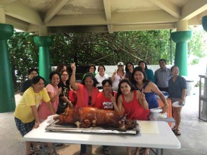 Former garment workers pose for a photo during a reunion yesterday at the Micro Beach in Garapan. (Kimberly A. Bautista)