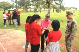 NAVFAC Marianas commanding officer Stephanie Jones teaches students about photovoltaic cells and solar power principles during the STEM Camp at the University of Guam in Mangilao on July 8. (NAVFAC MARIANAS PUBLIC AFFAIRS OFFICE)